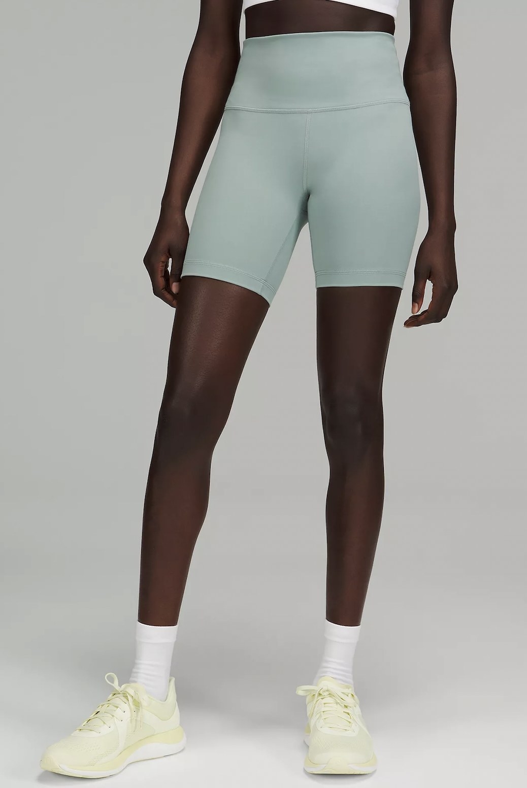 a model wearing the shorts in mint green
