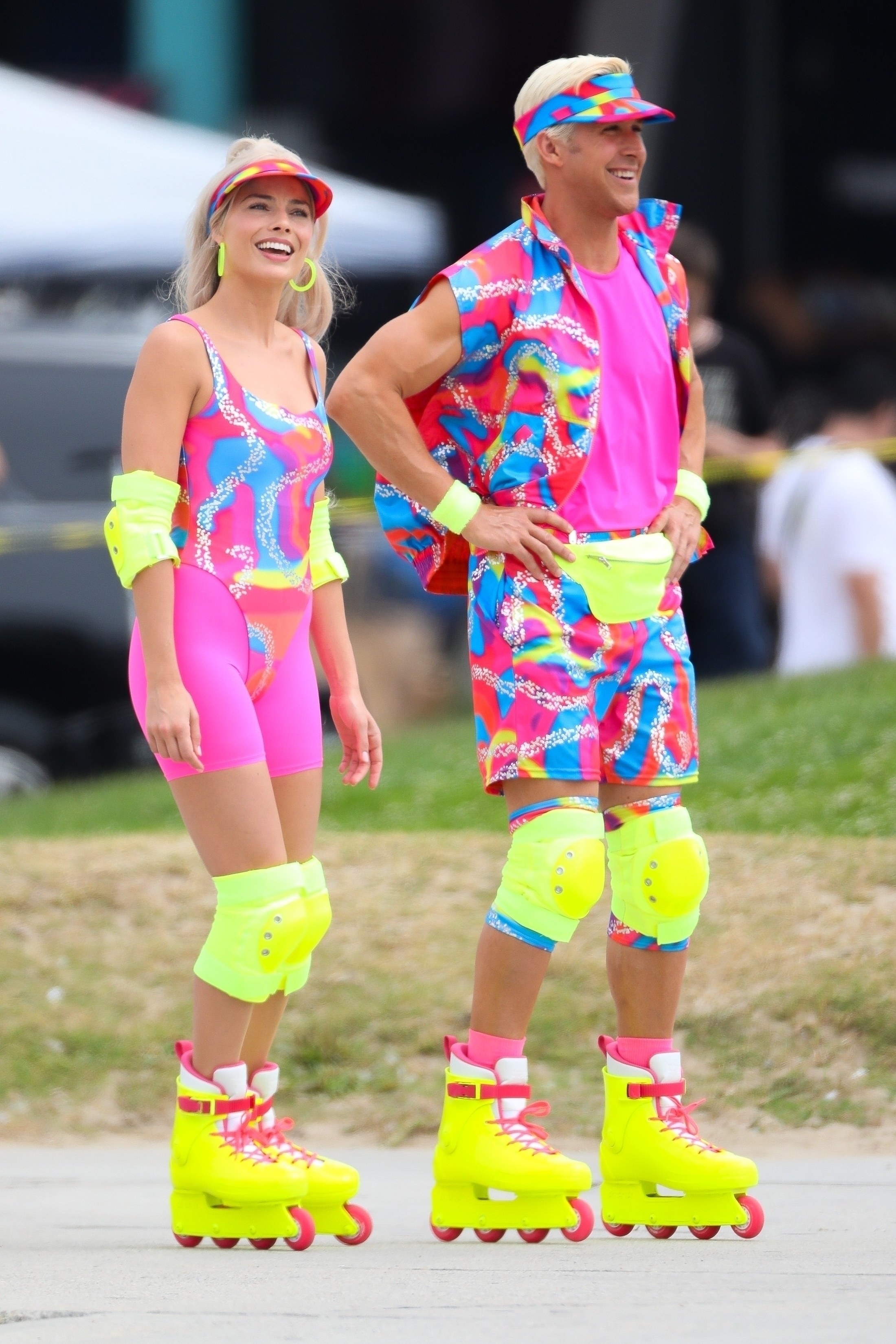 Margot Robbie and Ryan Gosling share a laugh as they film a rollerblading scene for &#x27;Barbie&#x27; in Venice Beach in very bright and colorful neon attire.