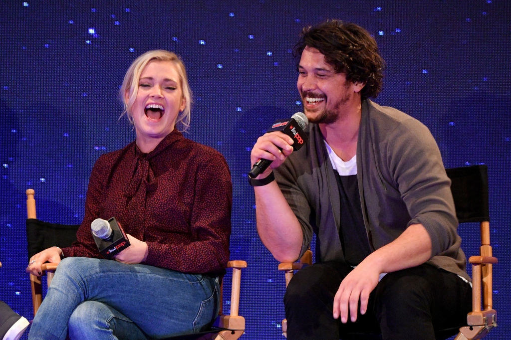Morley and Taylor laughing and  holding mics at a panel
