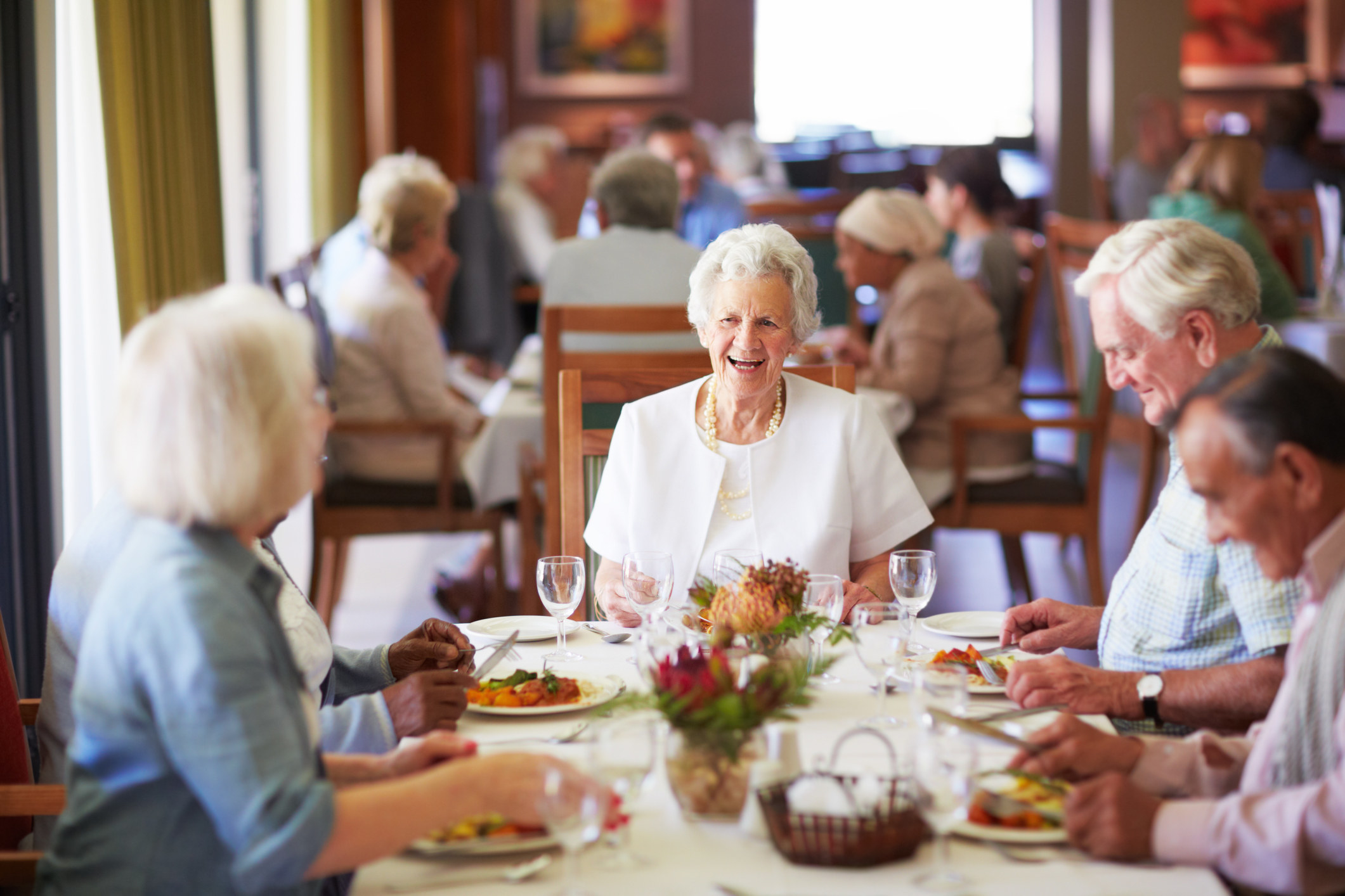 group of older people eating dinner