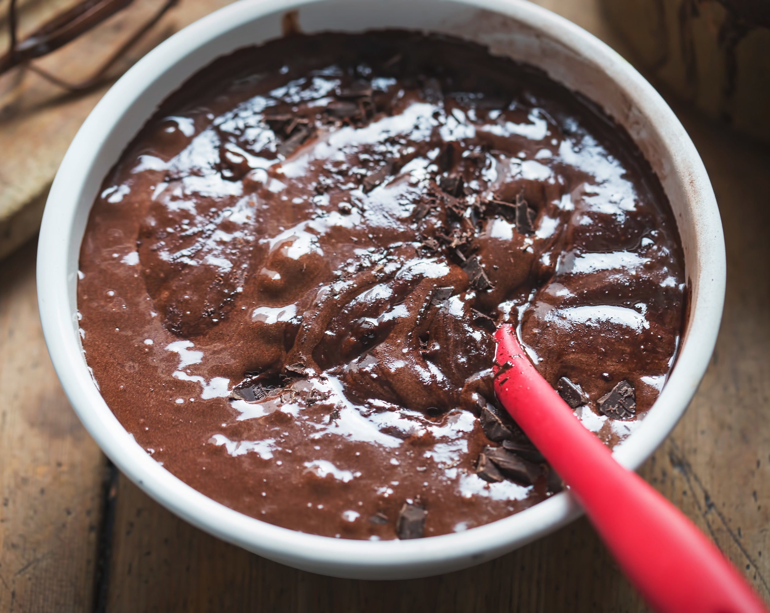 a pan of brownie batter being mixed