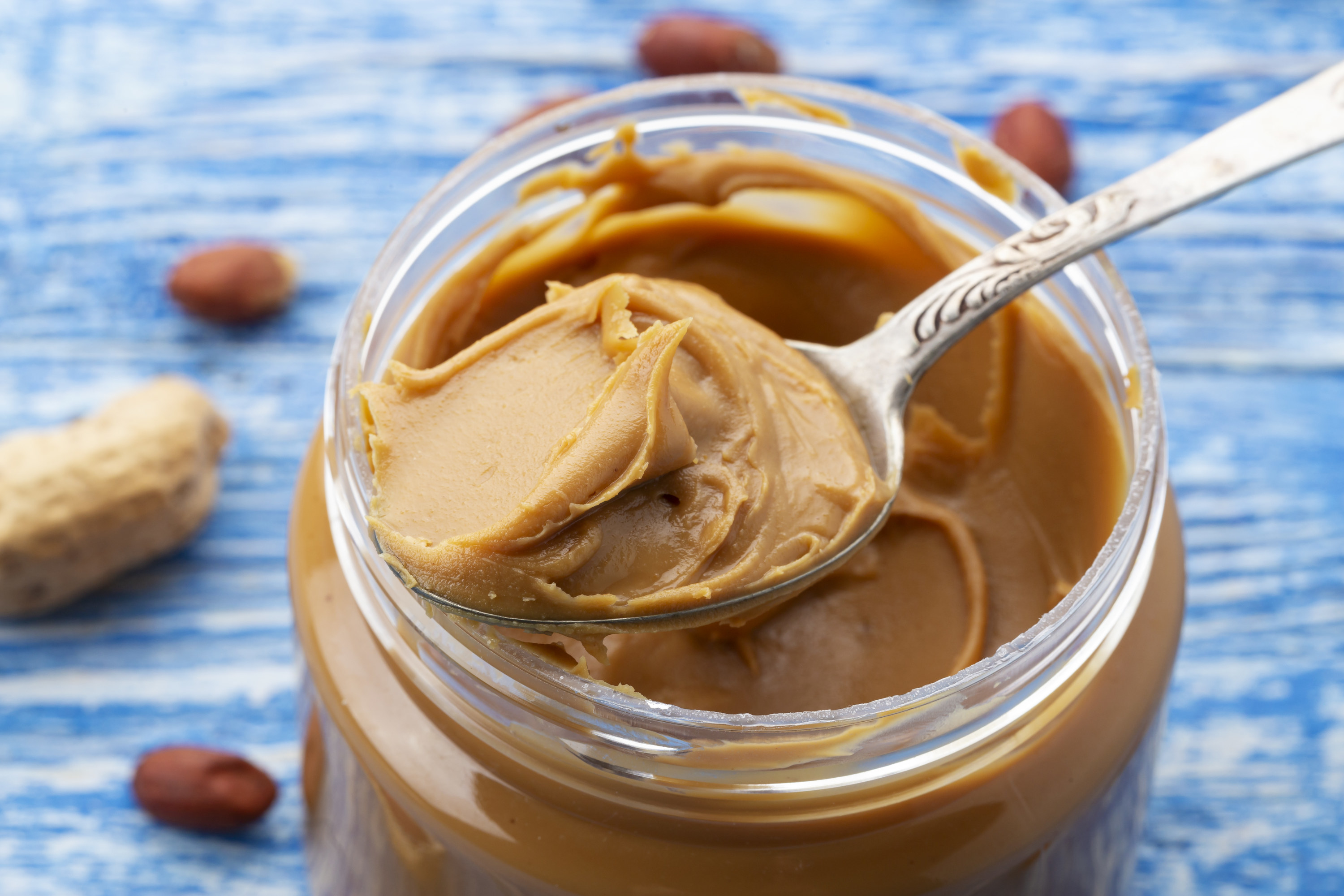 peanut butter being spooned out of a jar