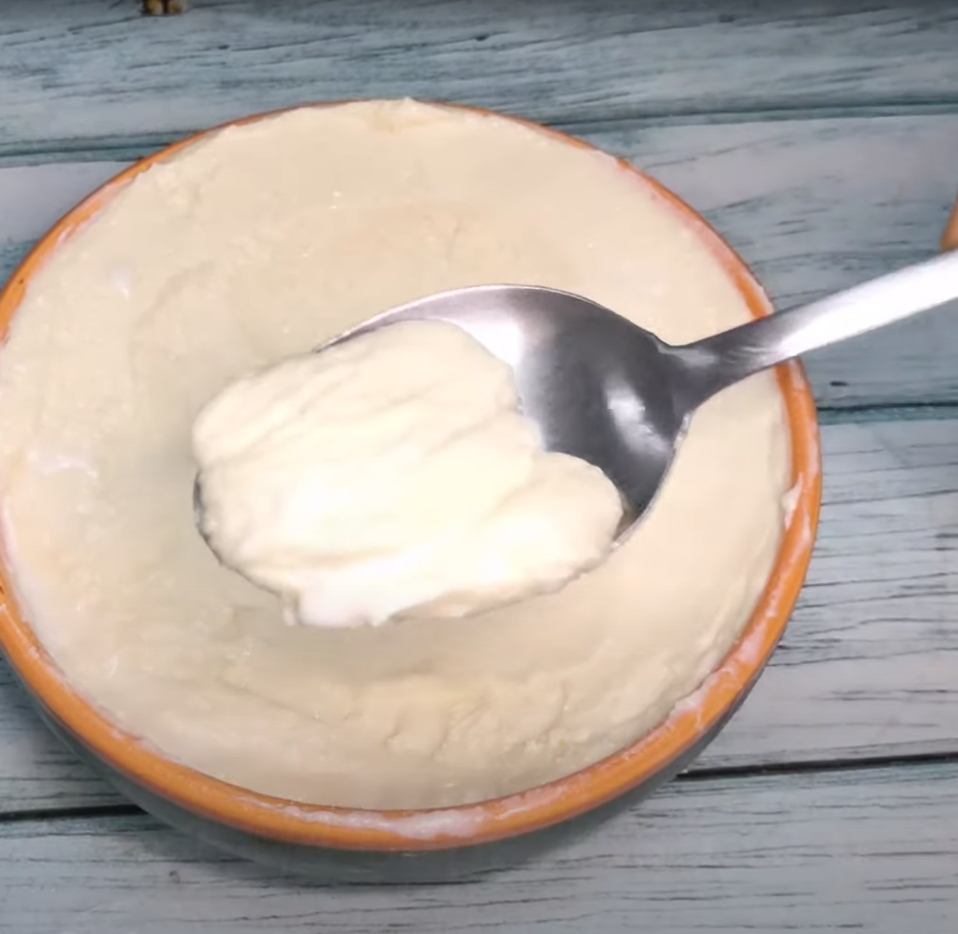 a bowl of mascarpone cheese with a spoon