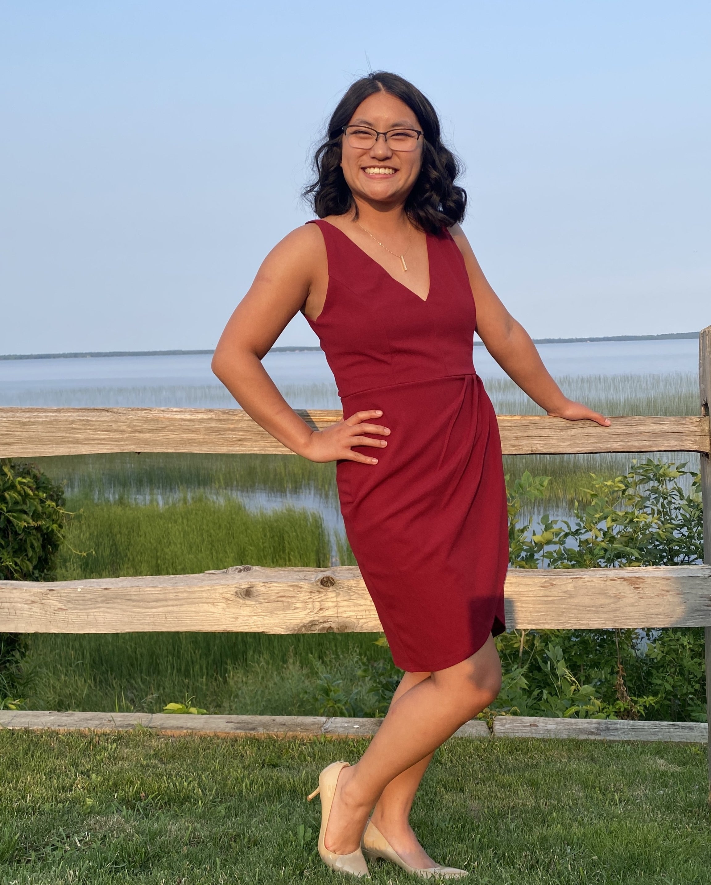 a reviewer wearing the dress in red