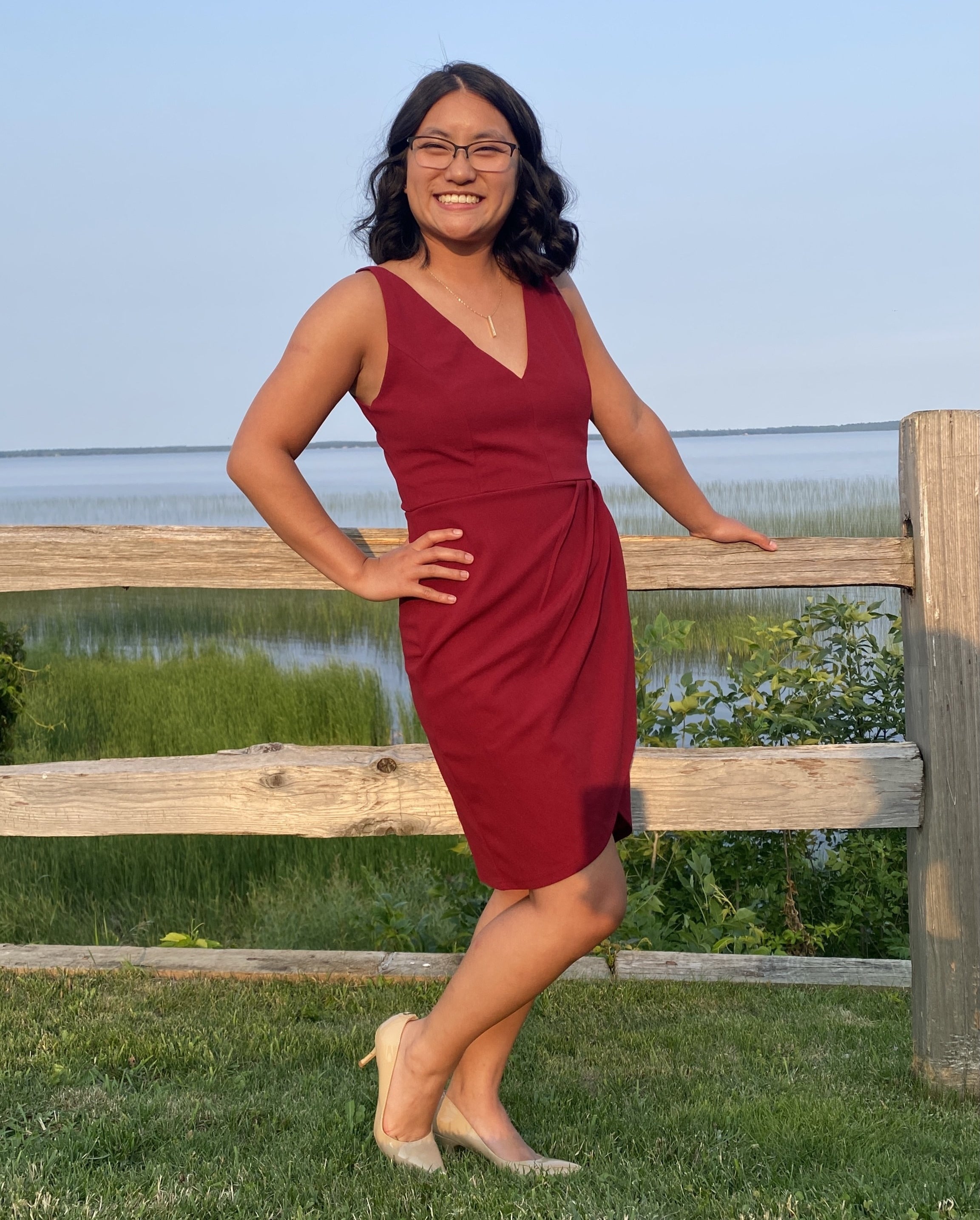 a reviewer wearing the dress in red