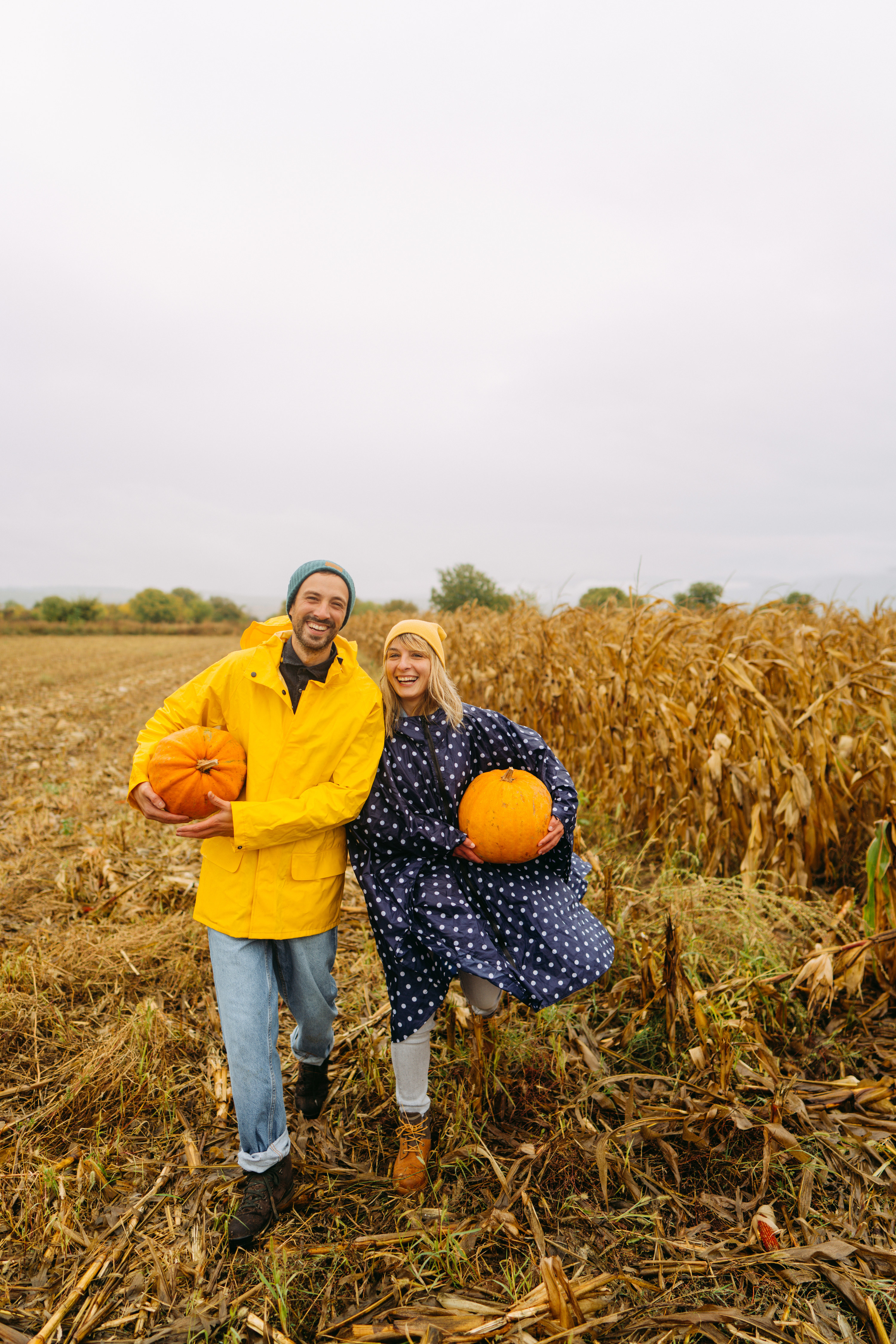 A couple taking a picture with pumpkin