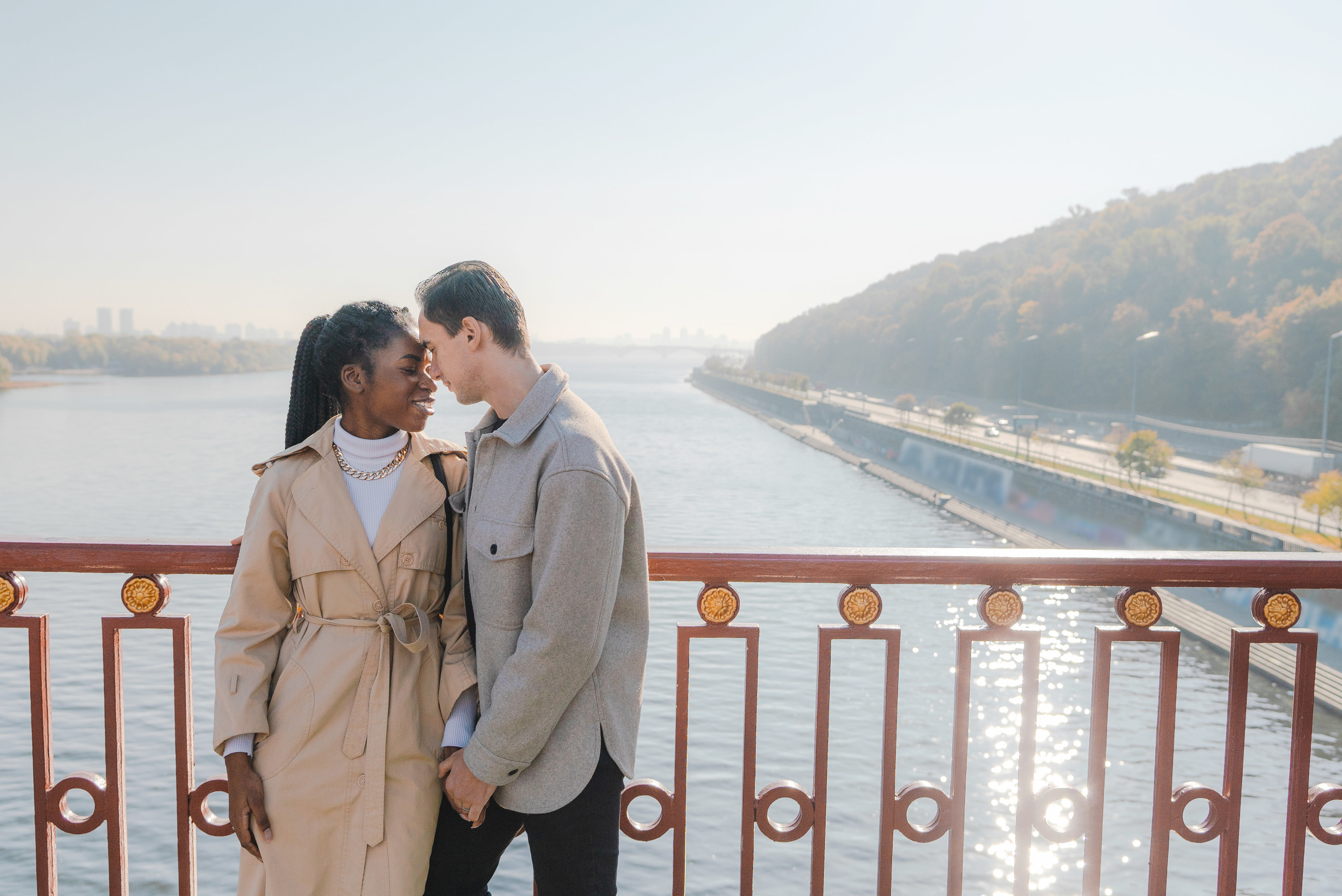 A couple kissing over a bridge