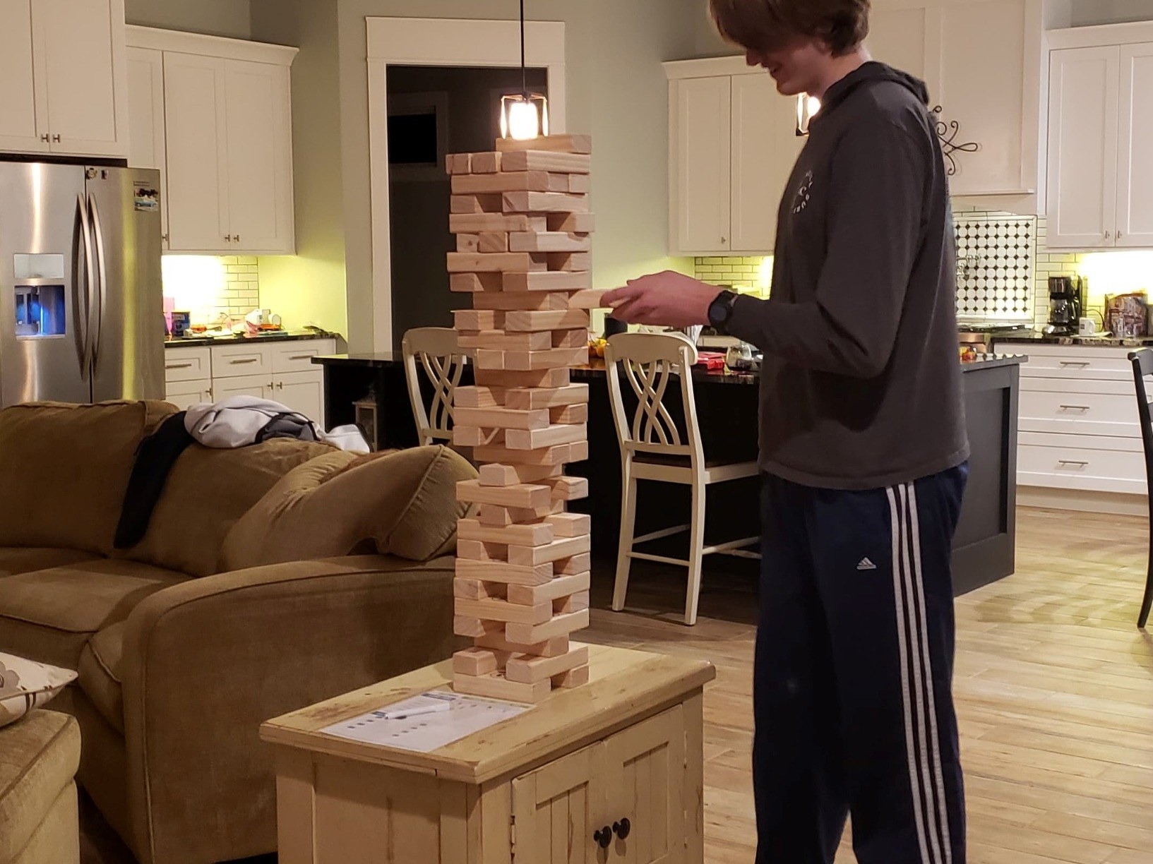 a reviewer image of a person standing next to the giant Jenga