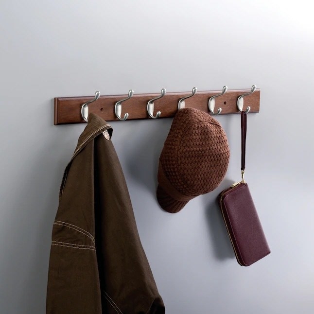 a bark and satin nickel  wall hook hanging a hat, purse, and jacket