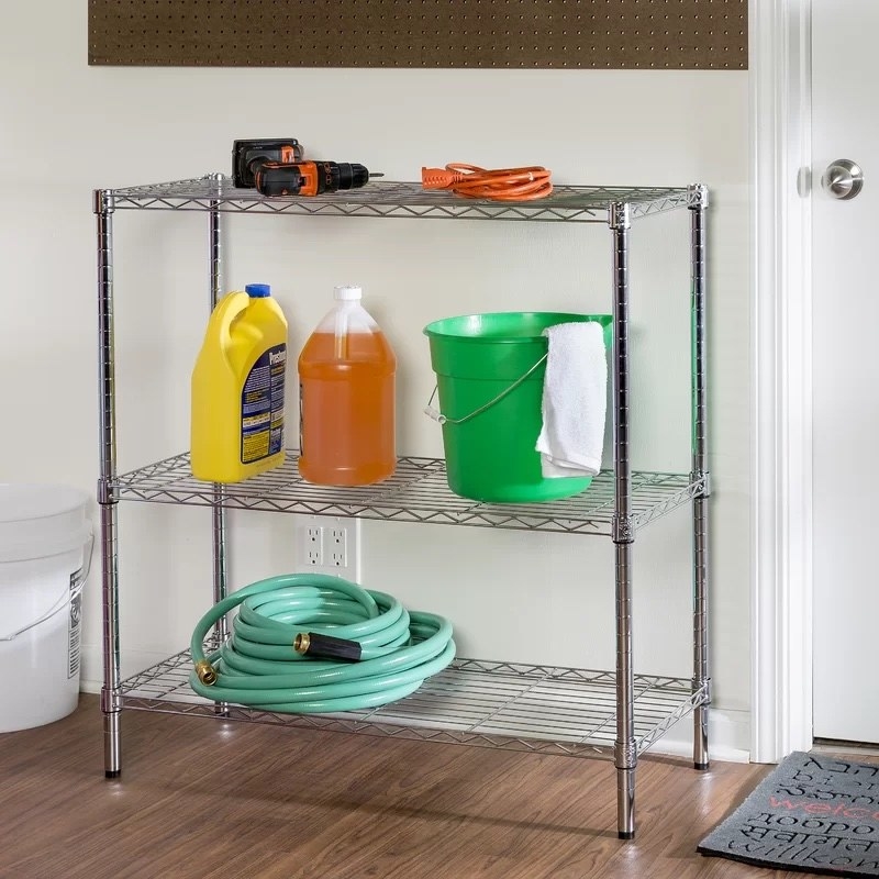 a metal shelving unit holding with garage equipment