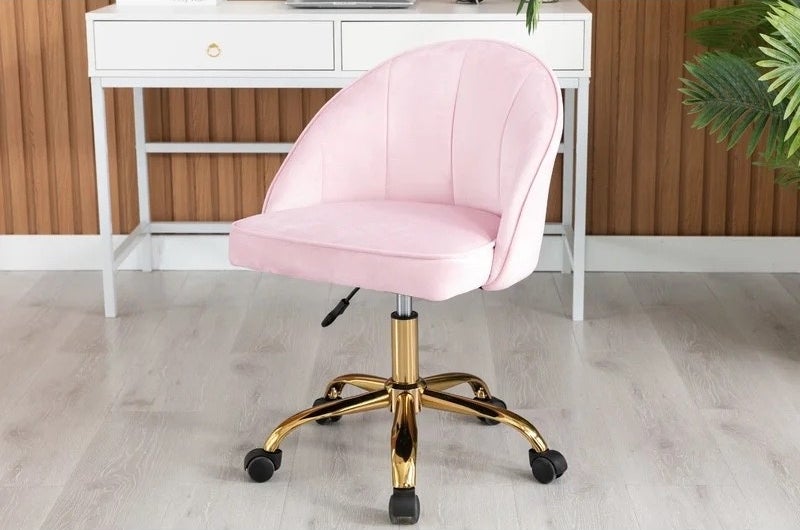 a pink and gold task chair in an office