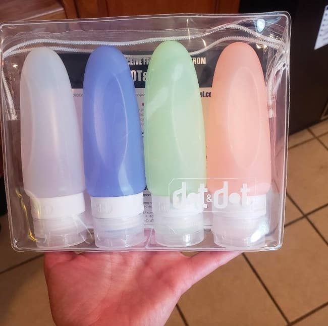 reviewer holding the silicone bottles