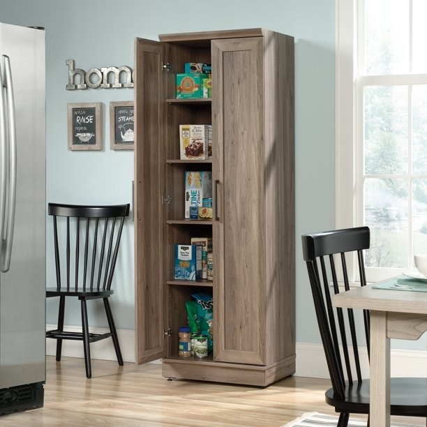 Storage cabinet in kitchen full of food