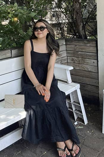 reviewer wearing the black dress
