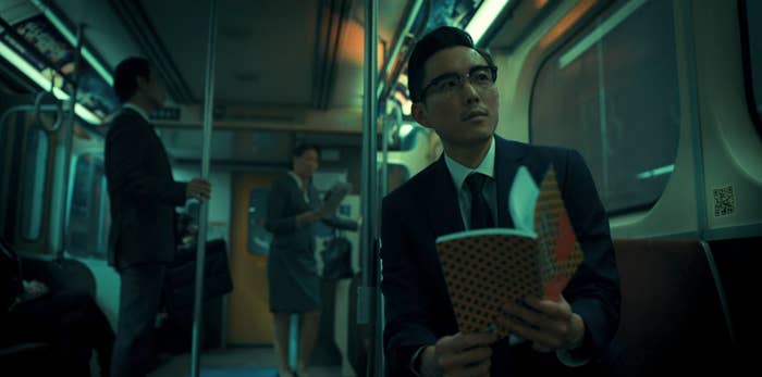 Ben sitting on a train reading a book