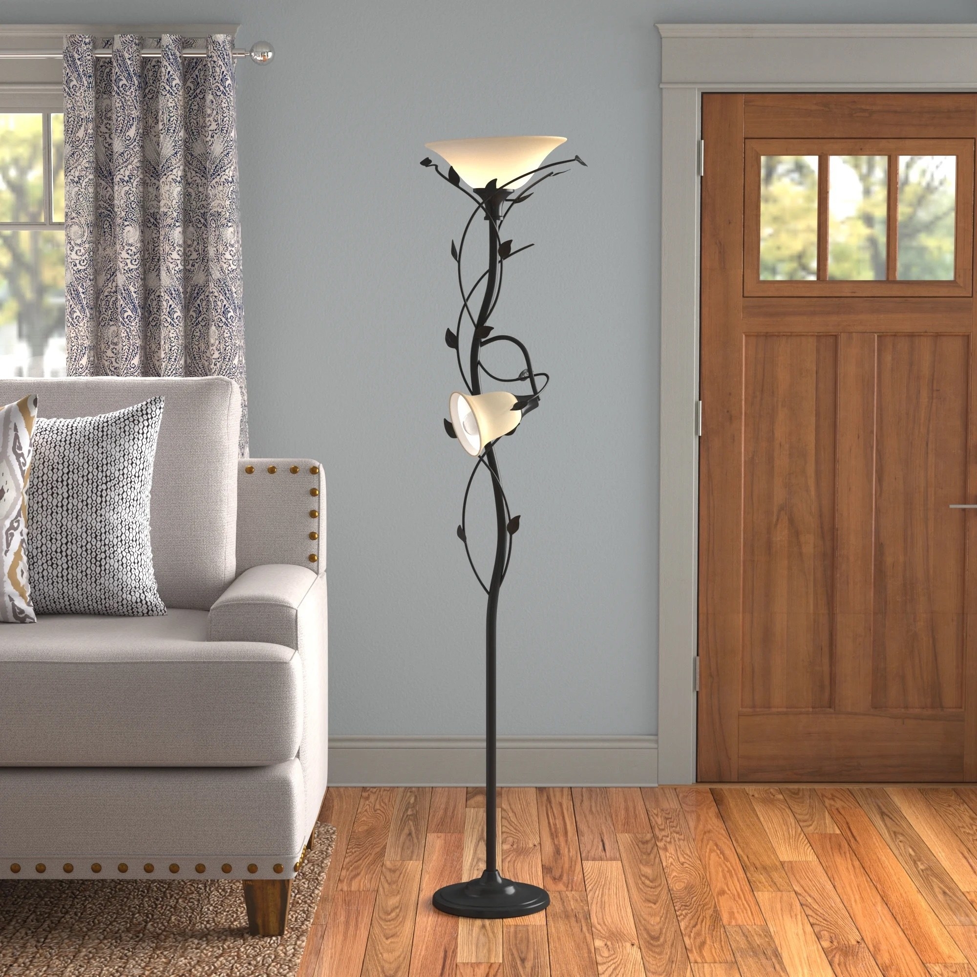 a floor lamp with metal leaves wrapped around the base