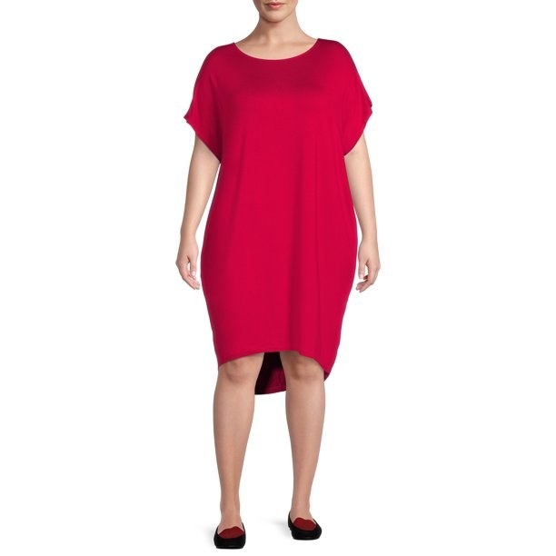 model wearing cranberry colored shift dress with dolman sleeves