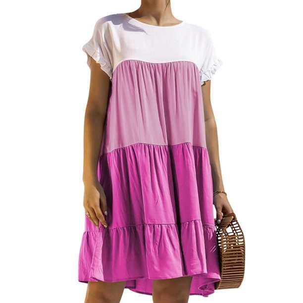 model wearing a pink and white color block tiered dress