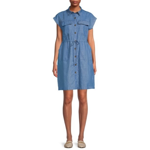 model wearing a short denim dress with buttons on the front and cinch waist