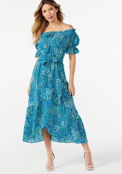 model wearing blue patterned faux wrap midi dress with sleeves off the shoulder