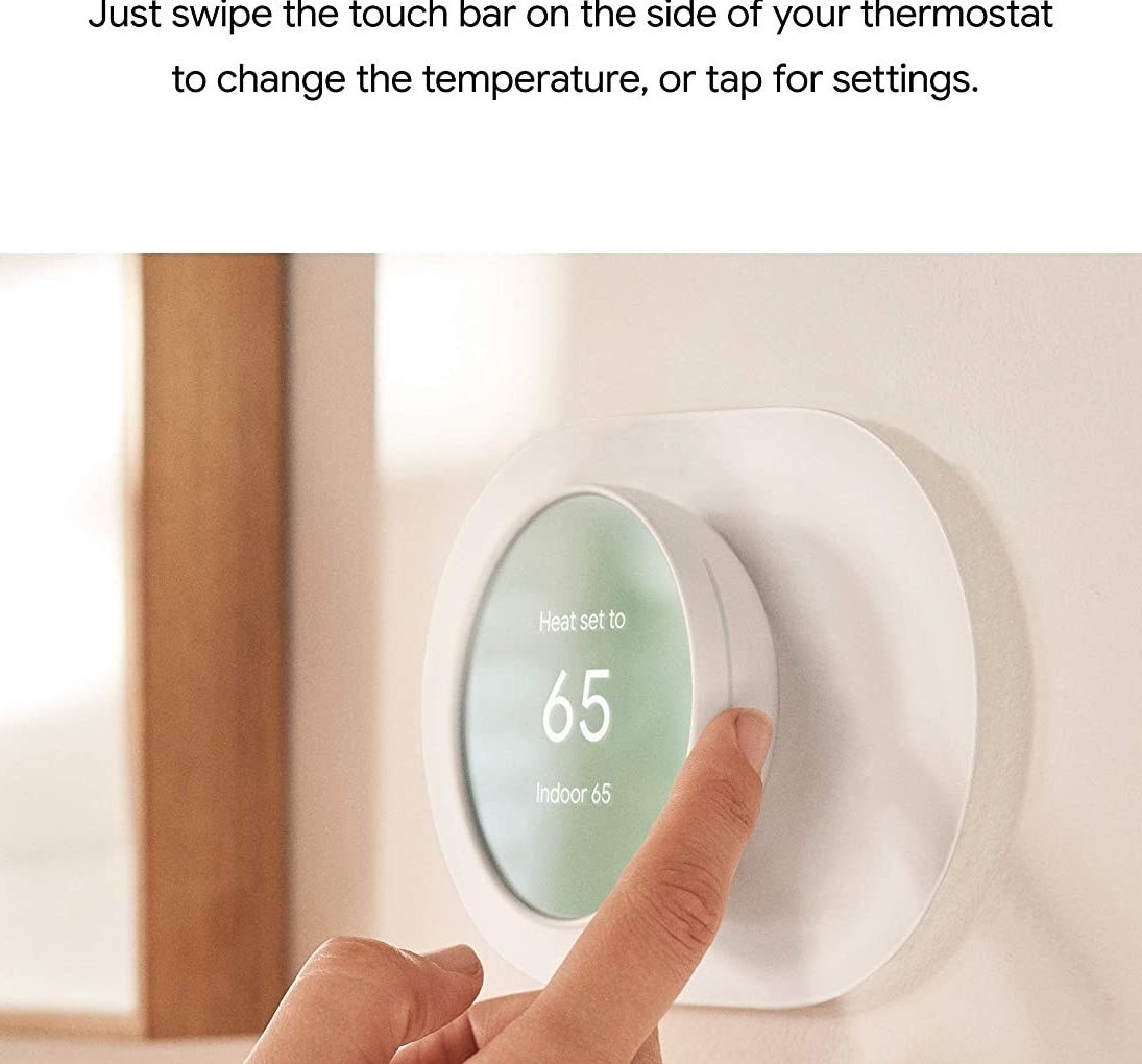 a person adjusting the thermostat using the side wheel