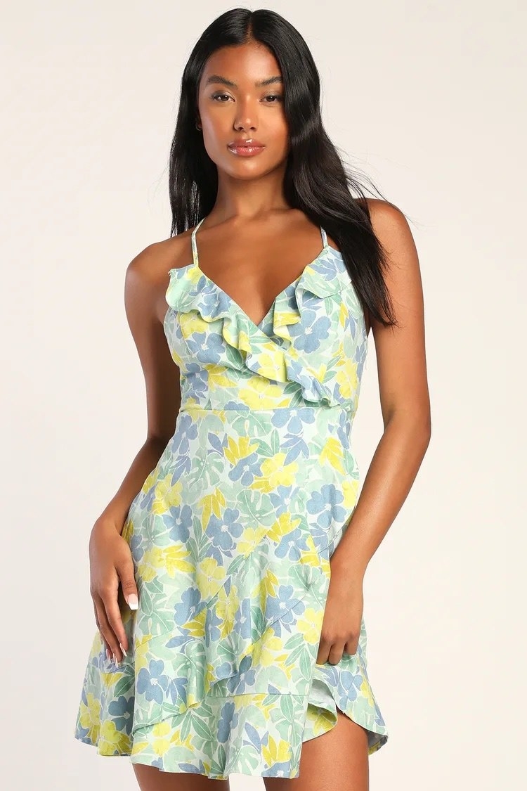 model wearing a blue, green, and yellow floral print mini dress