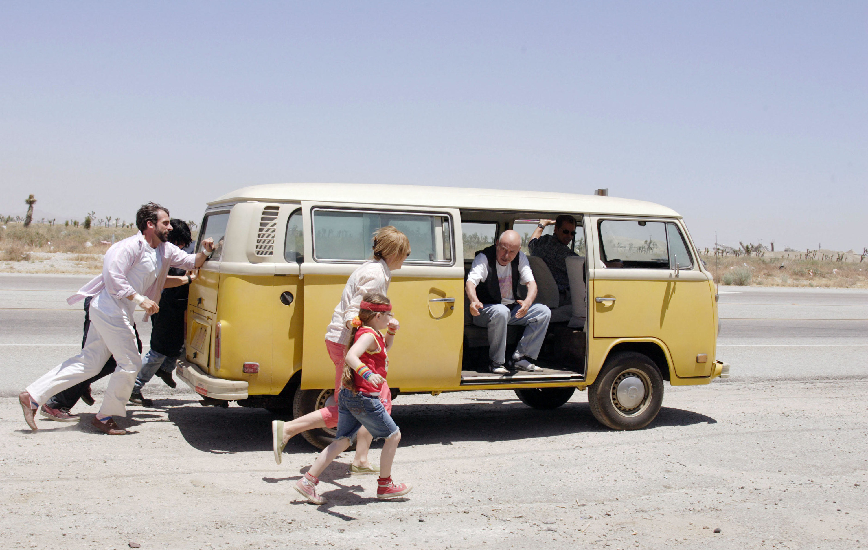 the cast of little miss sunshine chasing their yellow and white van through the desert