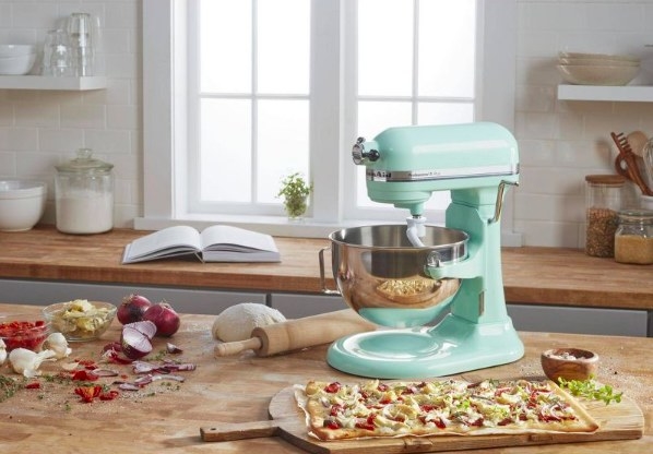 The stand mixer on a countertop surrounded by food