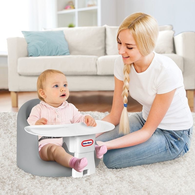 baby in foam seat with tray