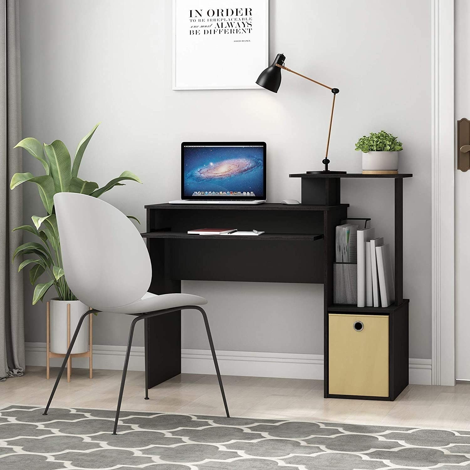 The desk with a computer and books on it