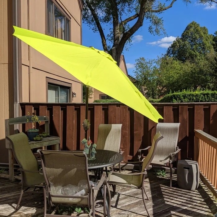 A reviewer&#x27;s neutral deck set up with a lime green umbrella