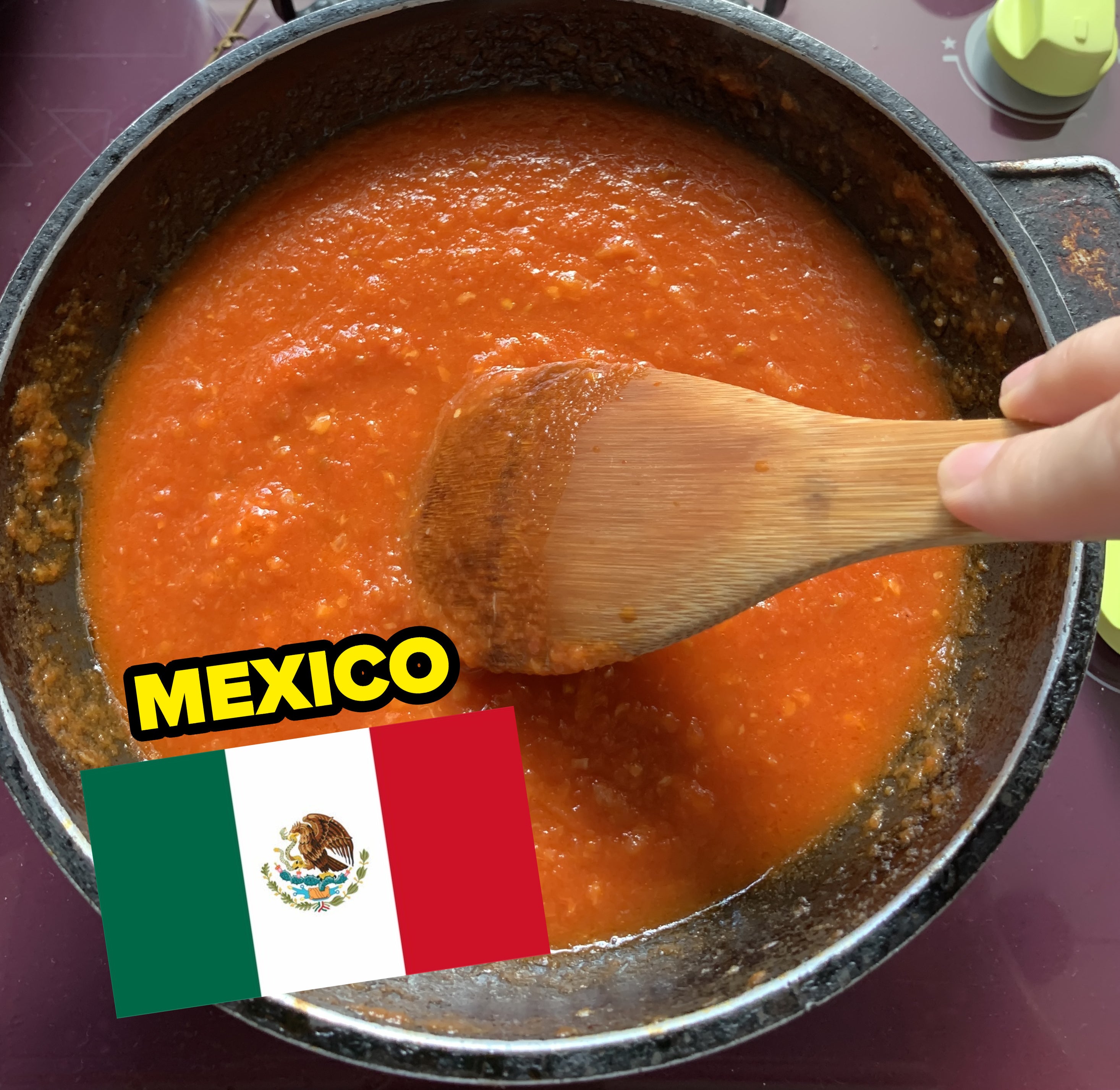 a pot of tomato sauce being stirred with a Mexican flag image