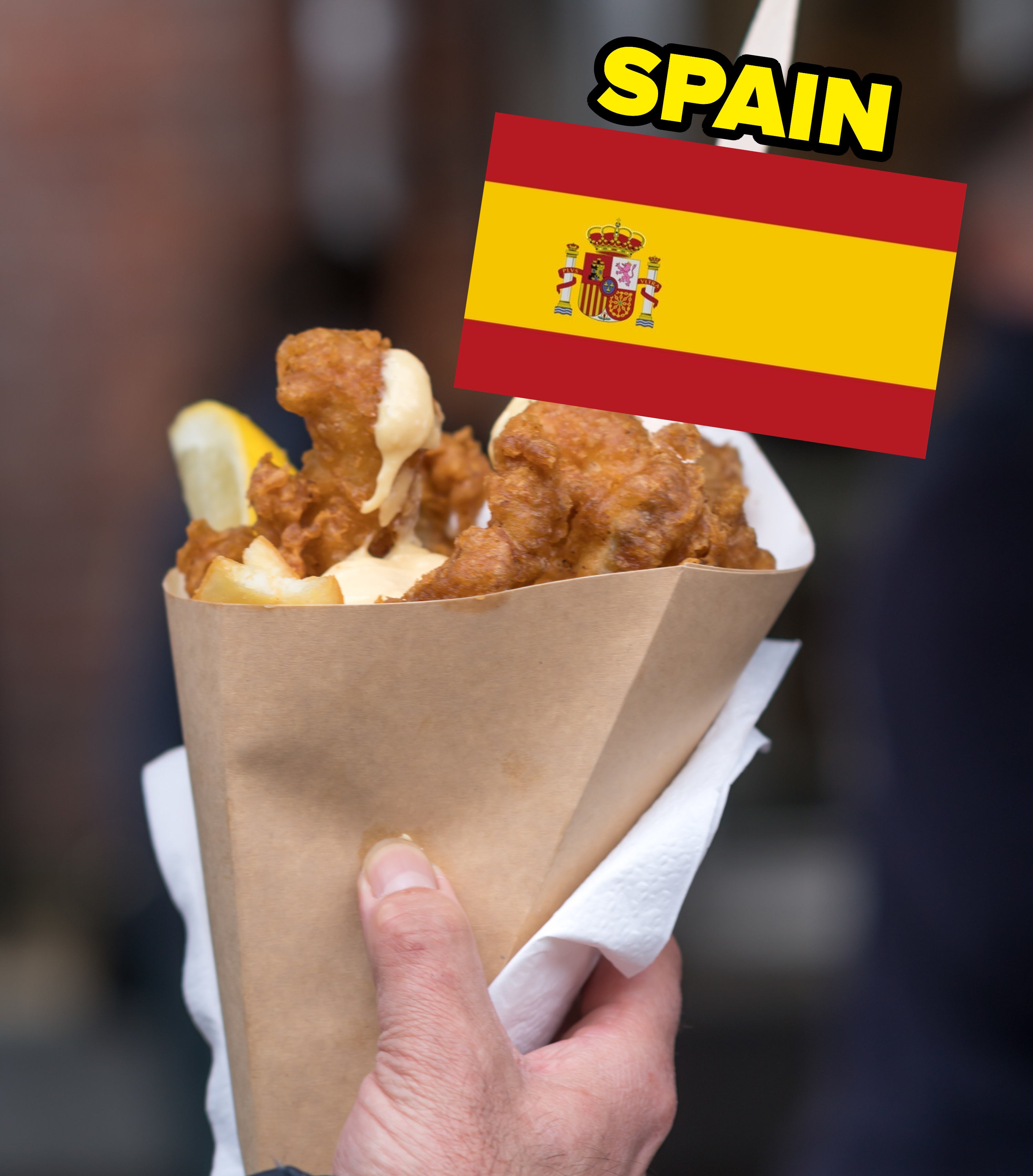 a person holding fried fish with a Spanish flag image