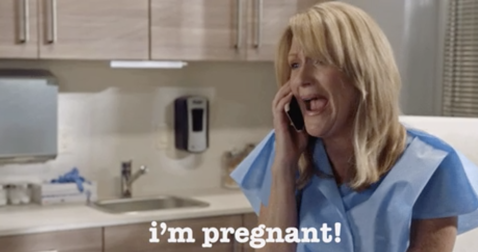 A woman saying, &quot;I&#x27;m pregnant!&quot; on the phone