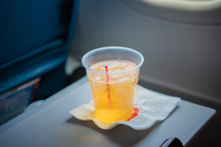 plastic cup in flight of ginger ale