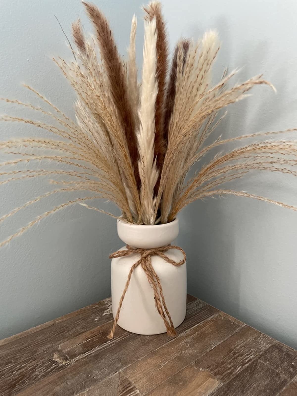 Reviewer&#x27;s dried grasses are shown in a vase