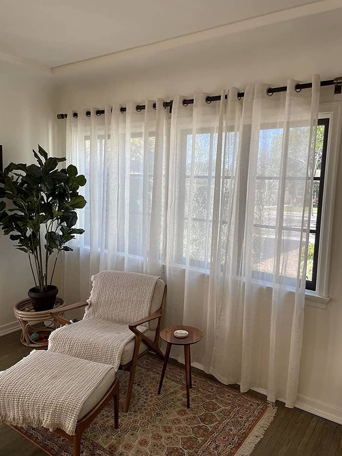 Reviewer&#x27;s white curtains are shown in a living room