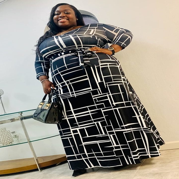 reviewer wearing the black and white dress