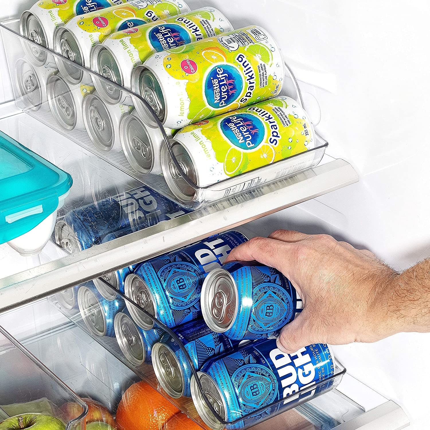 A person grabbing for a can in the fridge