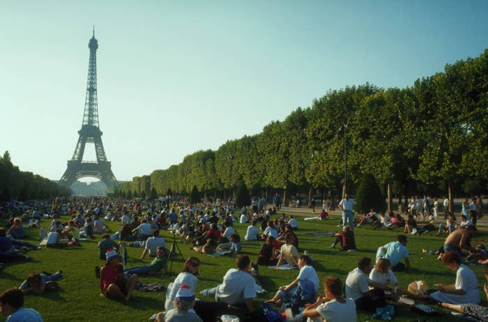 Tourists on the lawn of Champs de Mars in Paris.