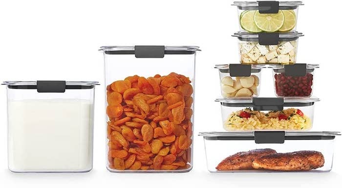 seven different-sized containers each filed with food stacked on top of one another