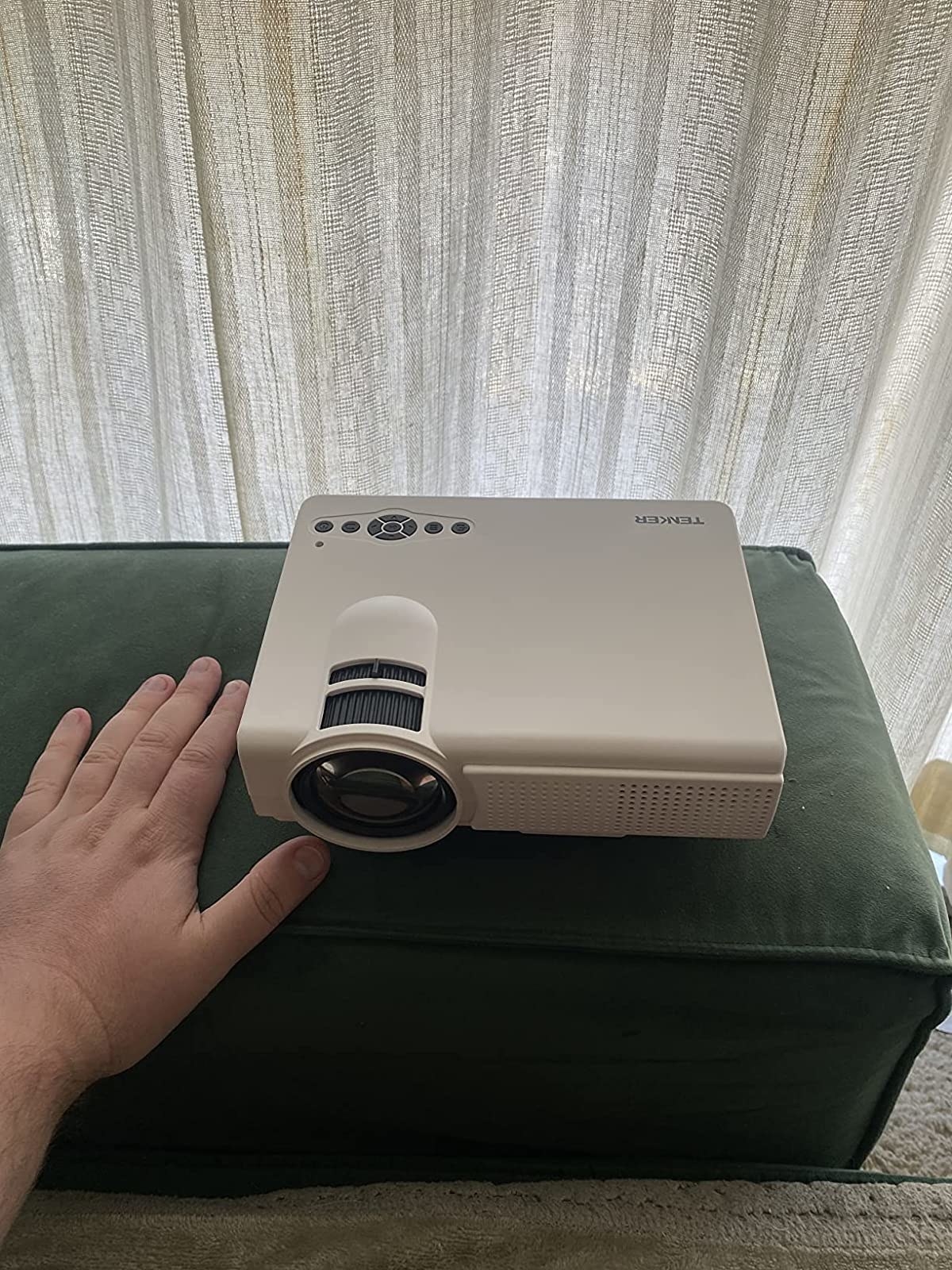 Reviewer&#x27;s hand next to projector
