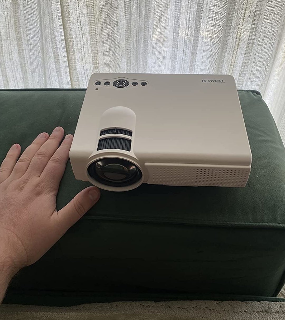 Reviewer&#x27;s hand next to projector
