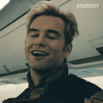 Anthony Starrs Homelander laughing at something on a plane