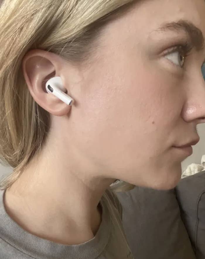BuzzFeed editor with white earbud in ear