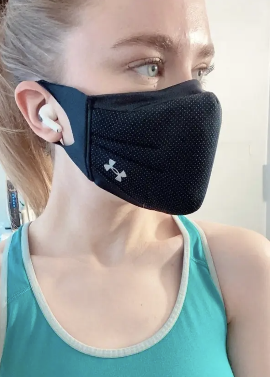 BuzzFeed editor wearing the headpones with a mask on