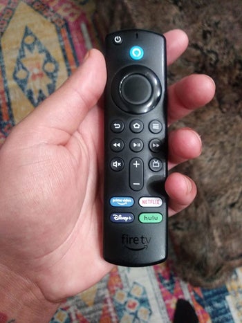 the fire tv remote in a reviewer's hand