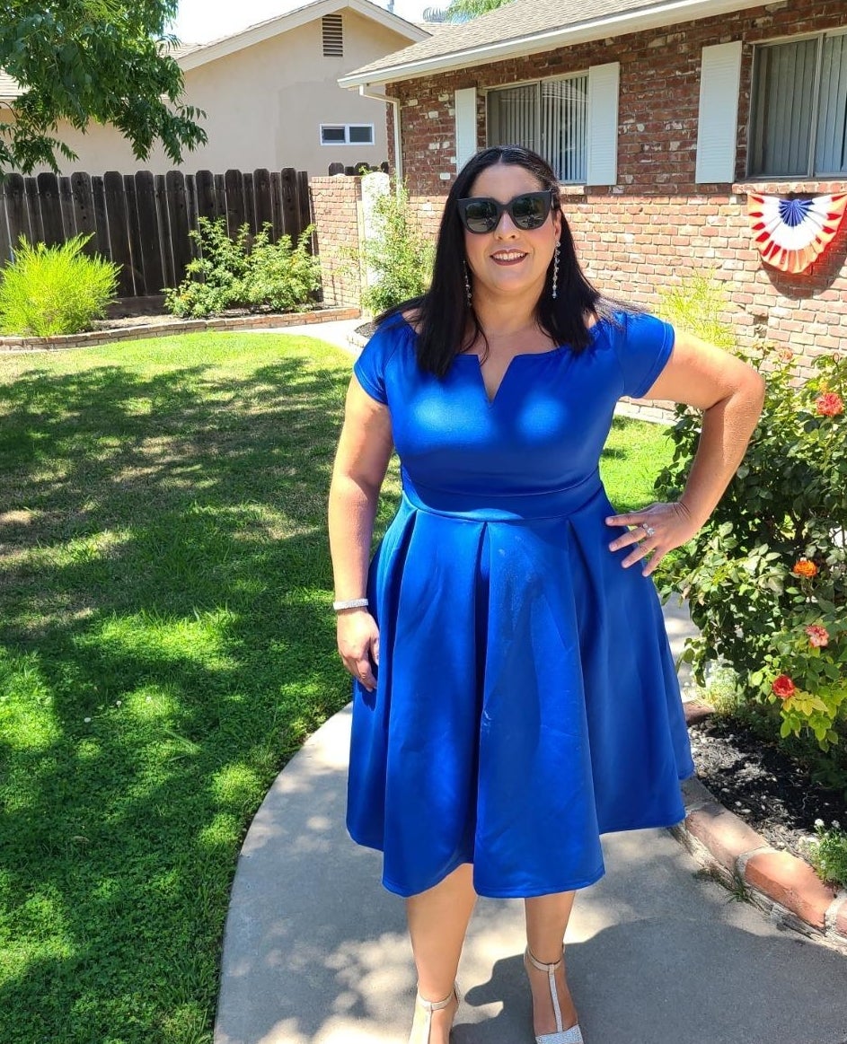 reviewer wearing the blue dress