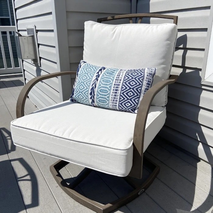 White cushions and a blue and white pillow in a reviewer&#x27;s yard