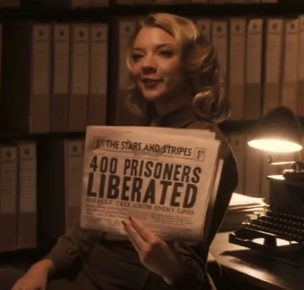 Natalie Dormer as Private Lorraine holding a newspaper in Captain America